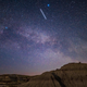 The Starlink 27 satellites, visible as a bright line in the sky over Dinosaur Provincial Park in Alberta, Canada on the same day as their 2021 launch from Cape Canaveral.